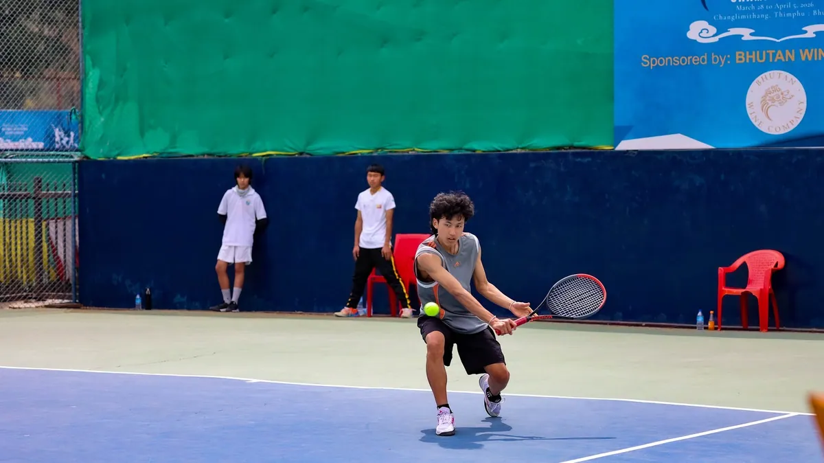 A junior stretching for a low backhand at the National Tennis Centre